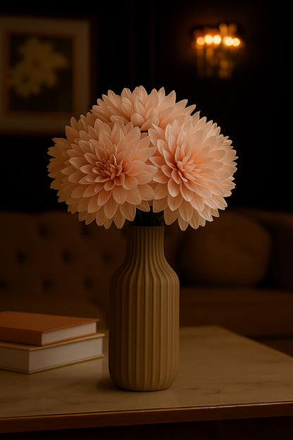 Vase with peach-colored flowers on a table in a dimly lit room