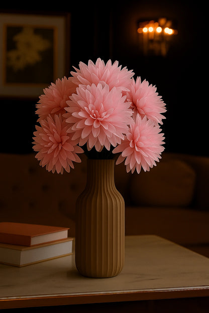 Pink flowers in a brown vase on a table with a blurred background