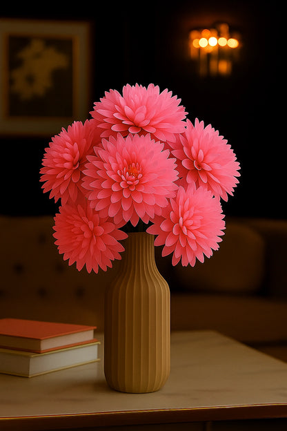 Pink flowers in a yellow vase on a table with a blurred background
