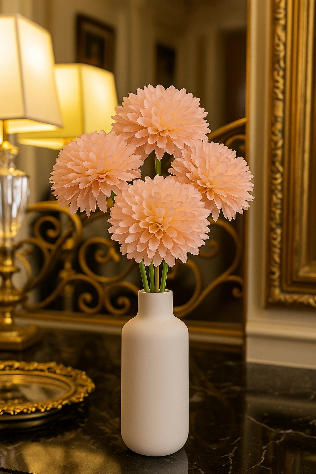 White vase with peach-colored flowers on a dark surface with decorative elements in the background
