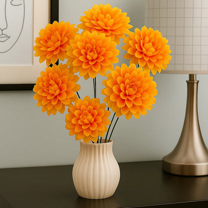 Orange flowers in a white vase on a dark surface with a lamp and framed picture in the background.