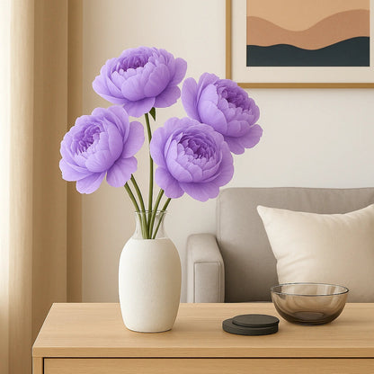 Purple flowers in a white vase on a wooden side table with a neutral-colored wall and framed artwork in the background.