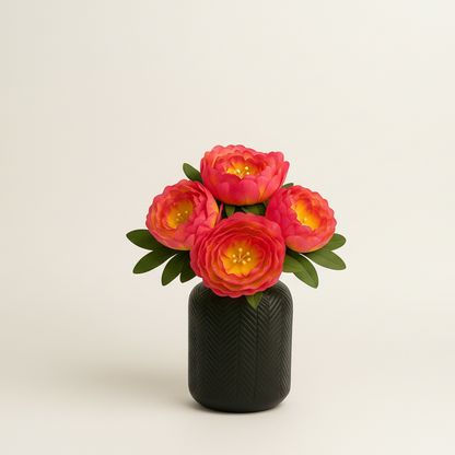 Small black vase with pink flowers on a light beige background