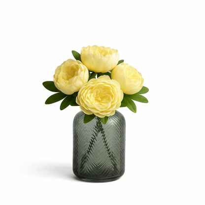 Small gray textured vase with yellow flowers on a white background