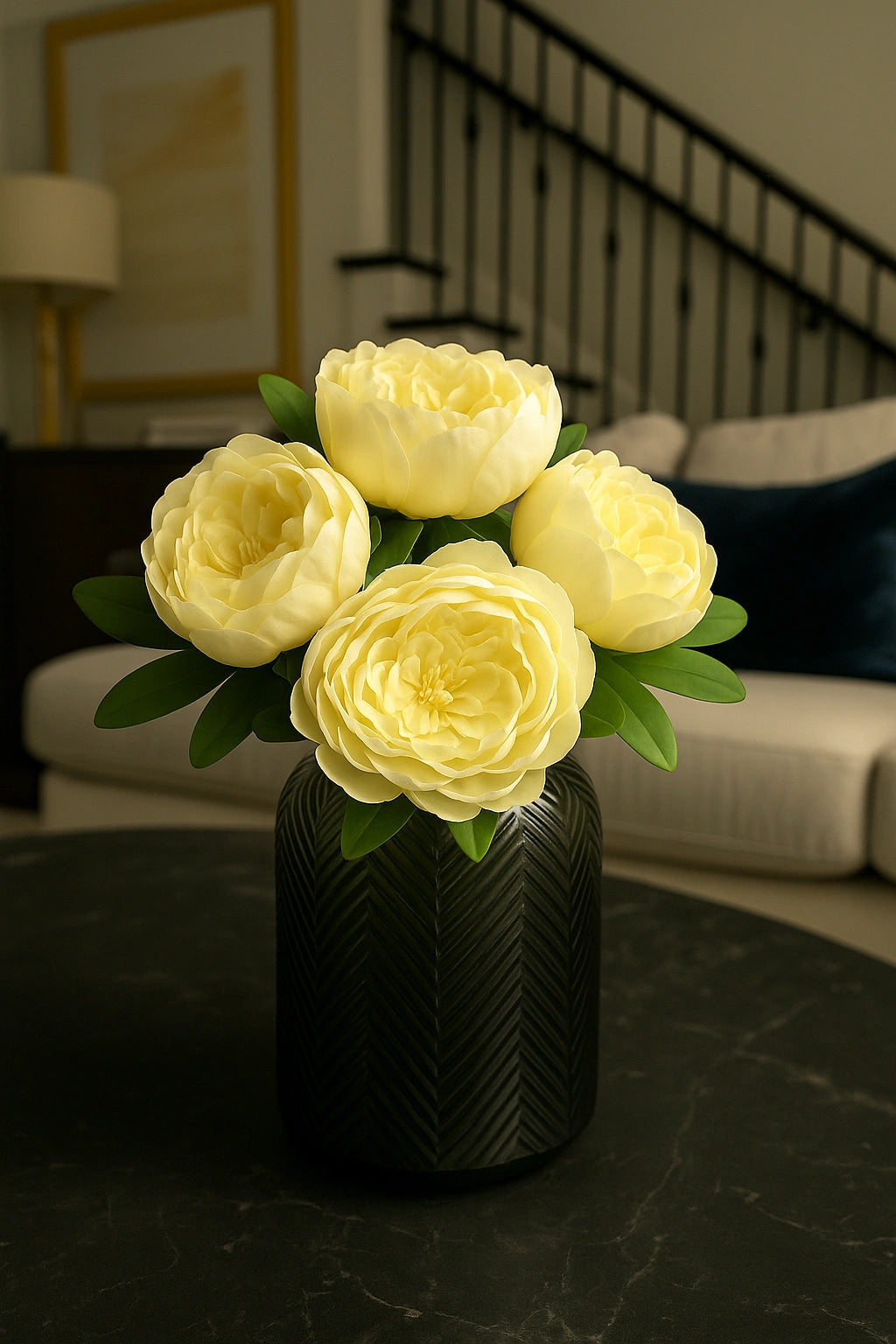 Yellow flowers in a black vase on a dark surface with a blurred indoor background