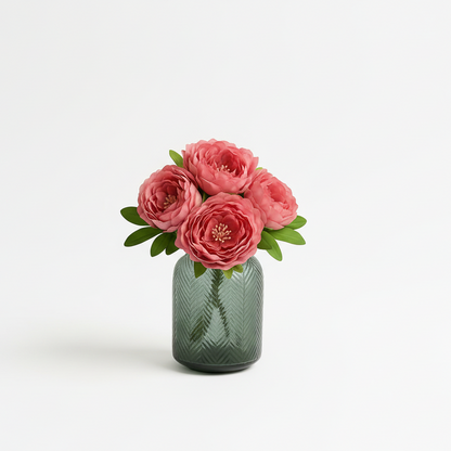 Green glass vase with pink flowers on a white background