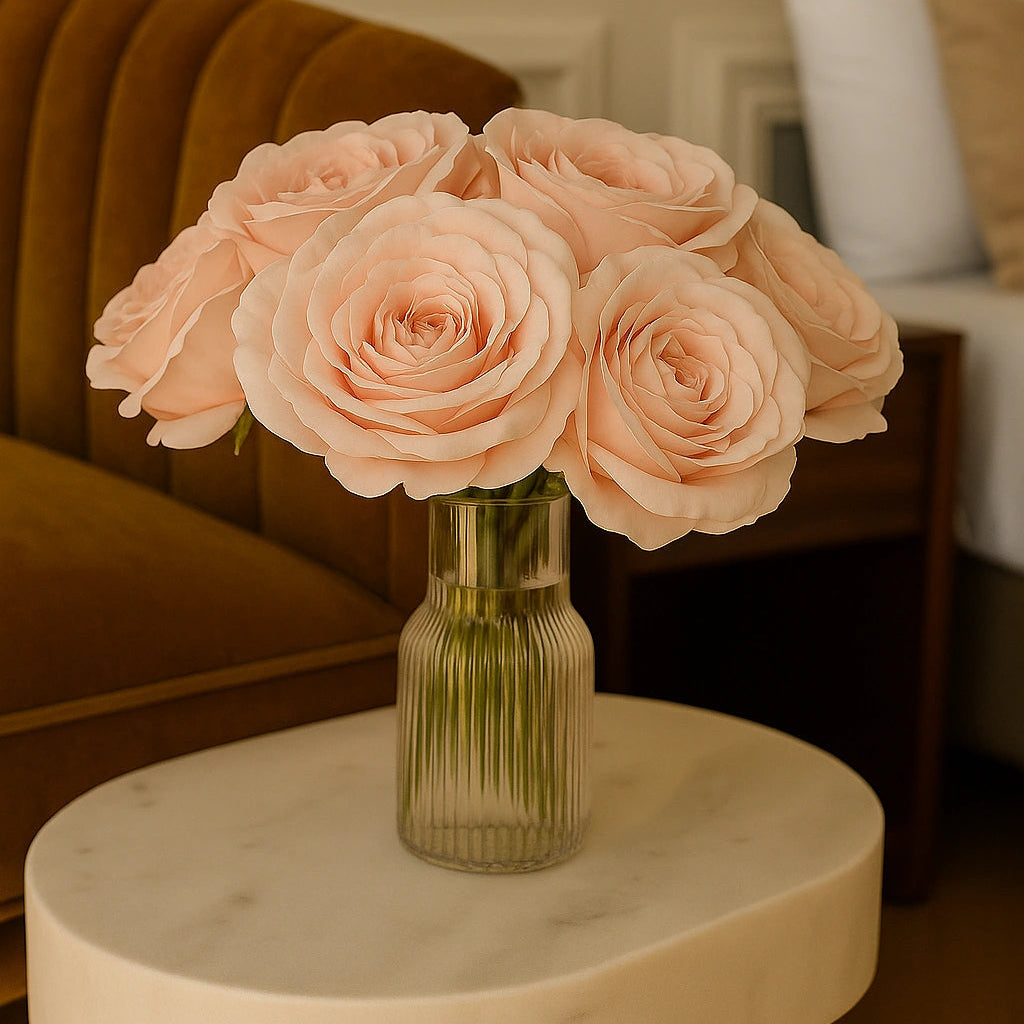 Bouquet of pink roses in a vase on a marble table with a blurred indoor background