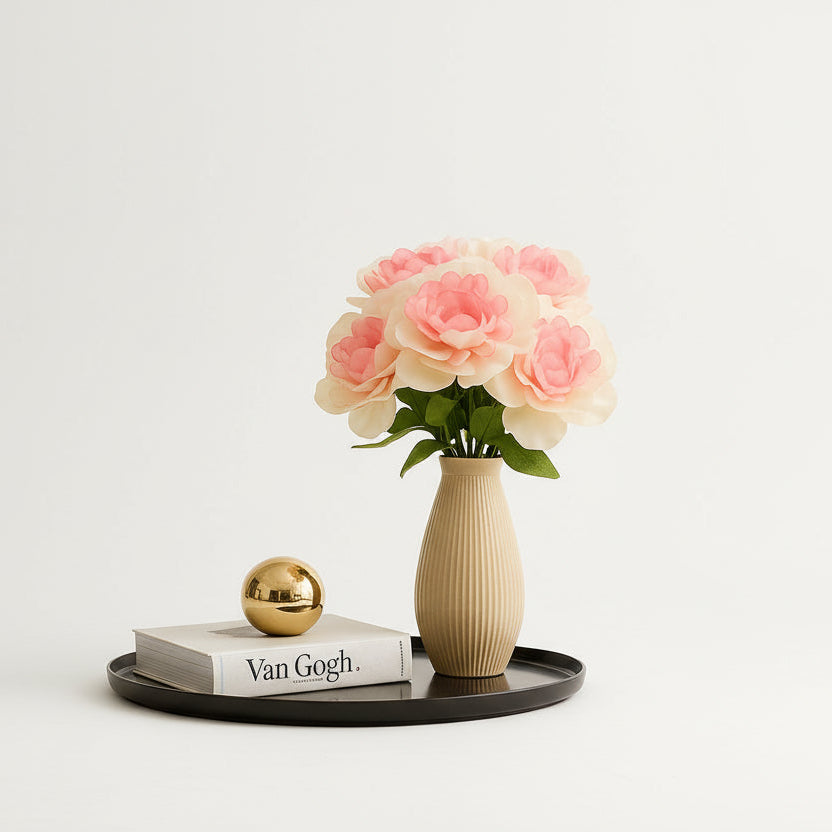 Decorative setup with flowers in a vase on a coffee table in a living room.